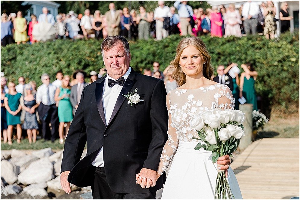 A playful Annapolis backyard wedding on the water featuring twinkle lights and greenery.