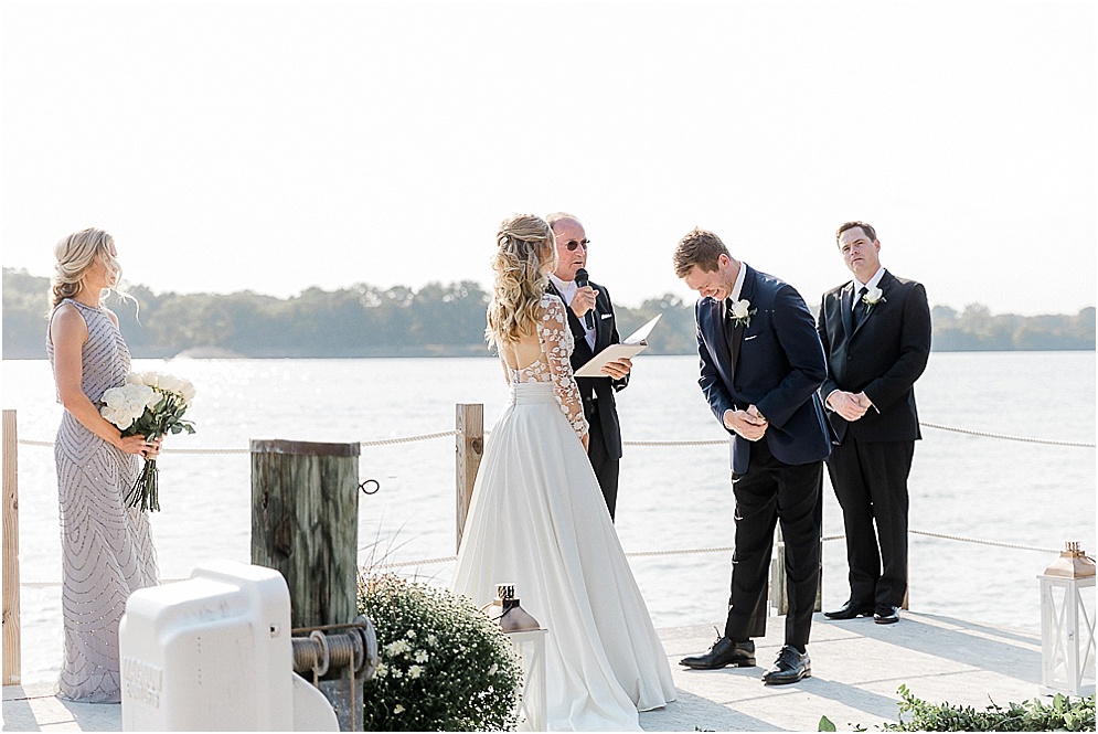 A playful Annapolis backyard wedding on the water featuring twinkle lights and greenery.