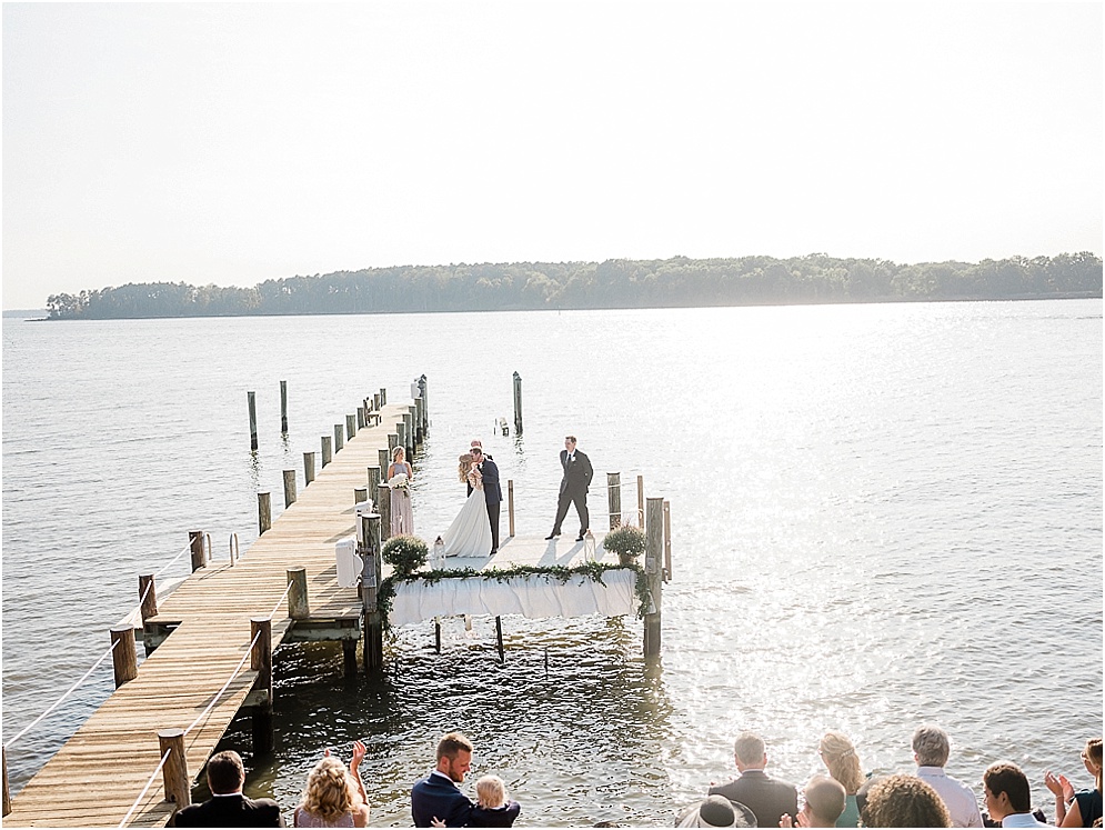 A playful Annapolis backyard wedding on the water featuring twinkle lights and greenery.