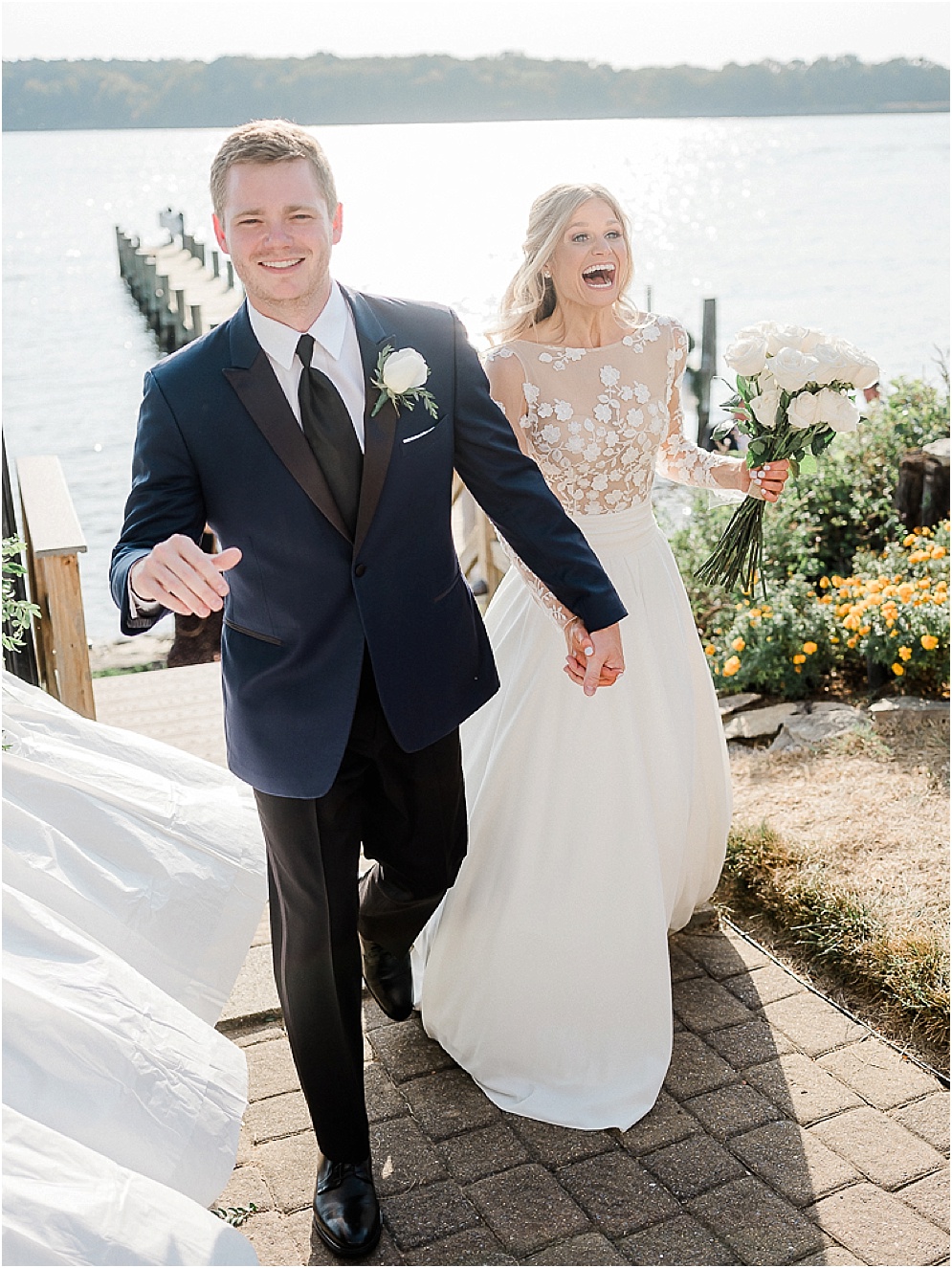 A playful Annapolis backyard wedding on the water featuring twinkle lights and greenery.