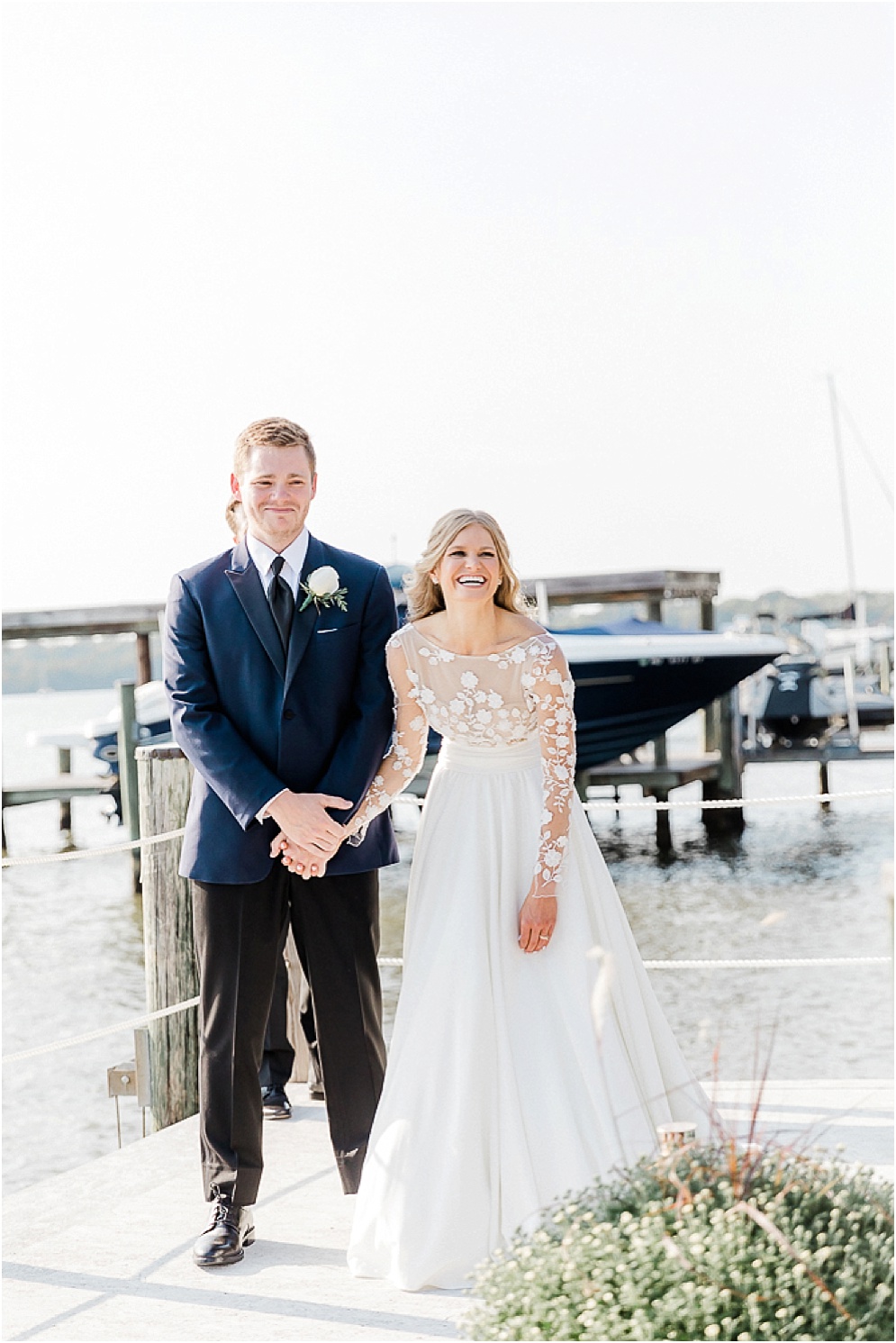 A playful Annapolis backyard wedding on the water featuring twinkle lights and greenery.