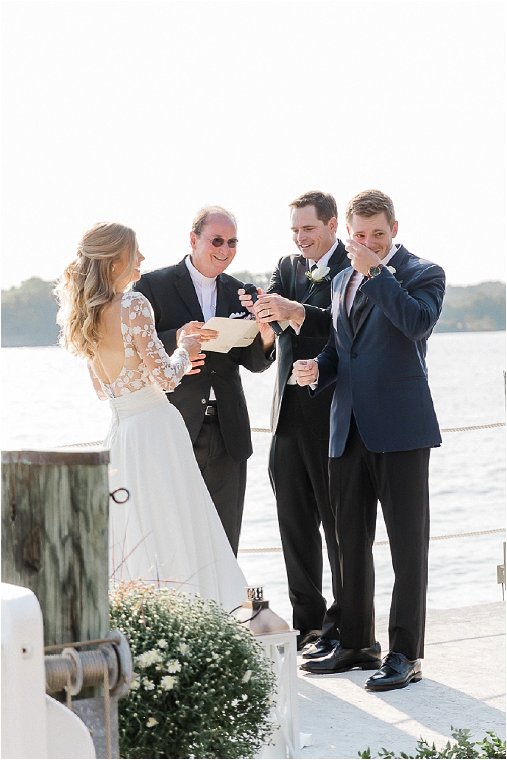 A playful Annapolis backyard wedding on the water featuring twinkle lights and greenery.