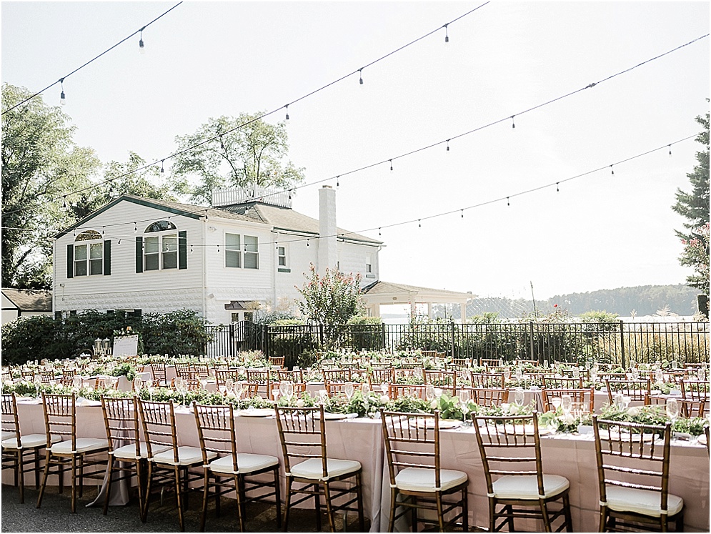 A playful Annapolis backyard wedding on the water featuring twinkle lights and greenery.