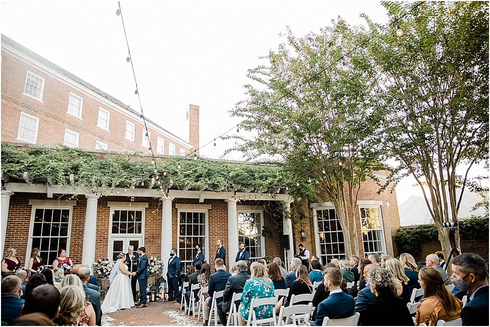 An Eastern Shore wedding in Downtown Easton, featuring deep red and purple hues and an incredibly joyful couple.