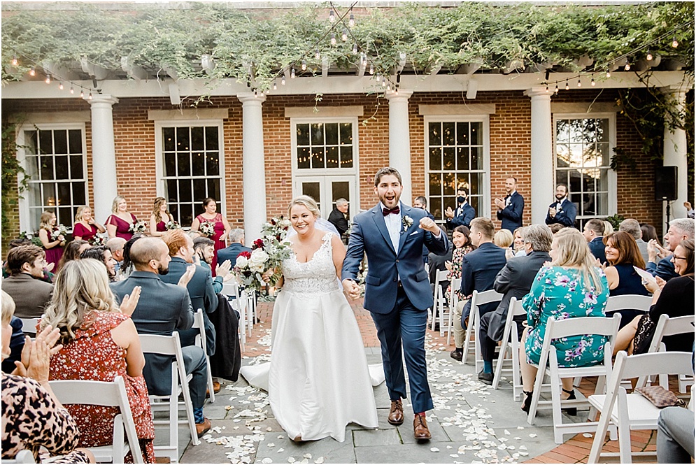 An Eastern Shore wedding in Downtown Easton, featuring deep red and purple hues and an incredibly joyful couple.