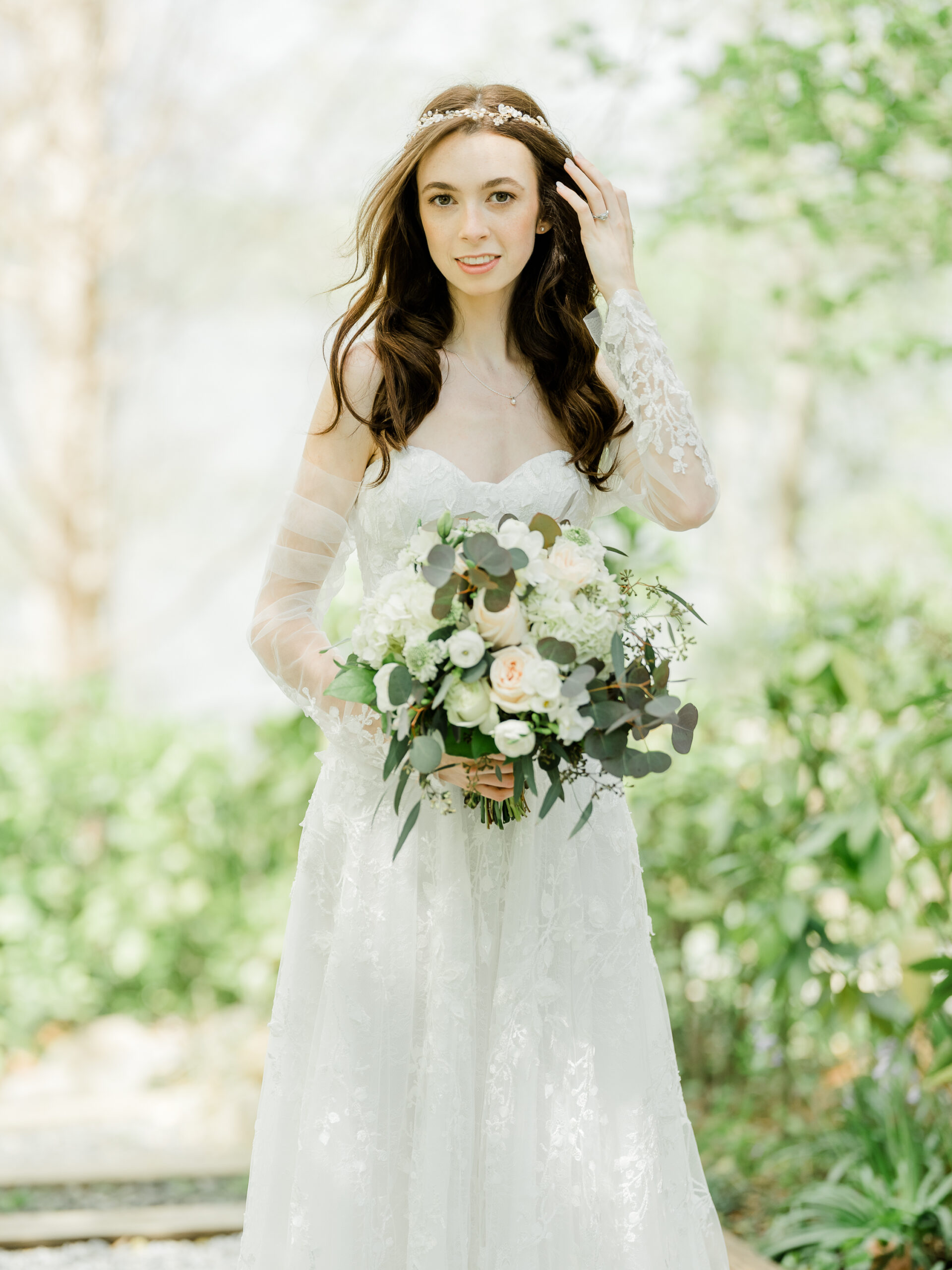 A stunning bride poses for the camera in a garden in Annapolis, Maryland.