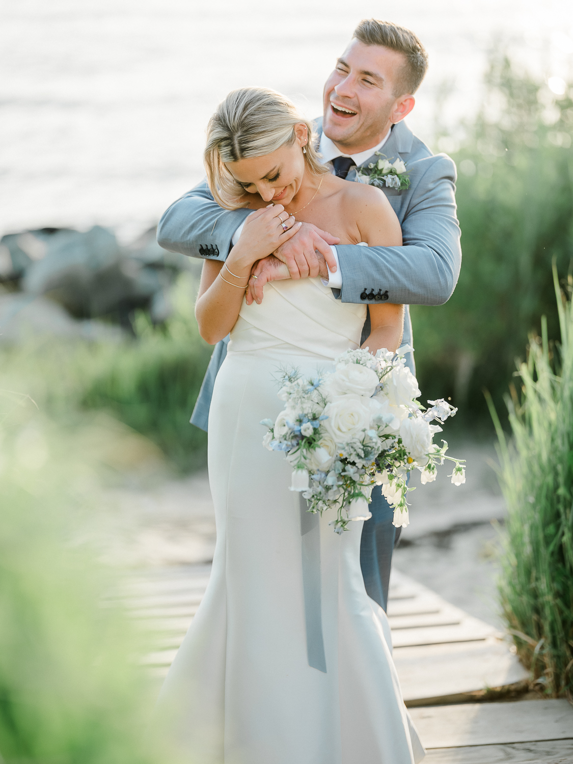 A white and baby blue coastal, chic wedding with romantic touches on the Chesapeake Bay on the Eastern Shore of Maryland.